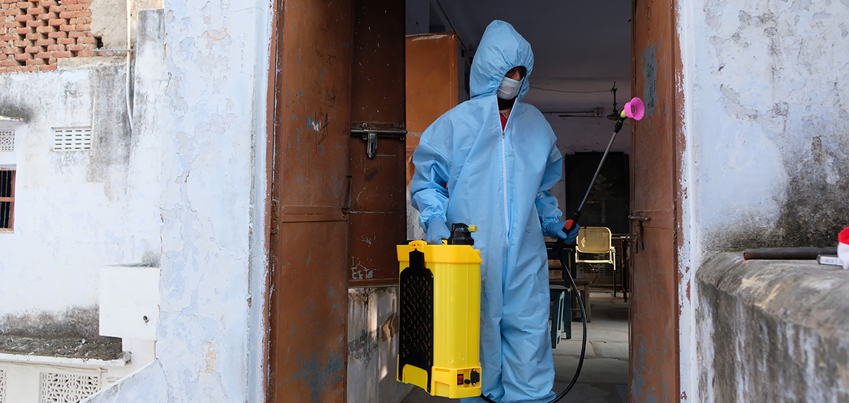 An Indian sanitary worker conducting disinfection of the interior during the COVID-19 pandemic