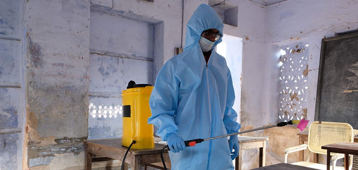 An Indian sanitary worker conducting disinfection of the interior during the COVID-19 pandemic